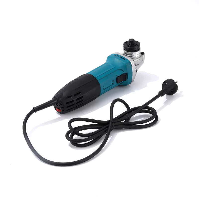 Corded 100 mm angle grinder, three-quarter view, with its mains lead coiled beside it